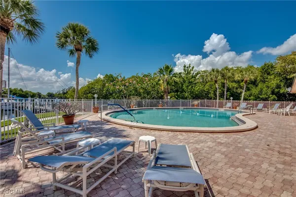 a view of a swimming pool with a patio and a garden
