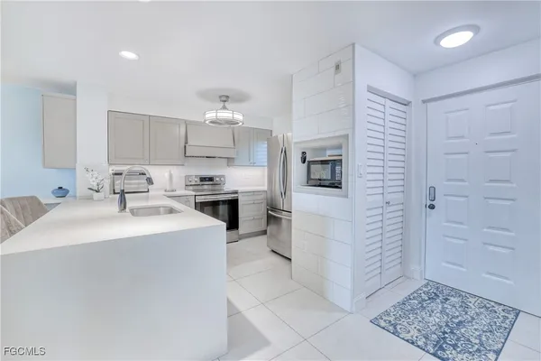 a kitchen with a sink cabinets and window