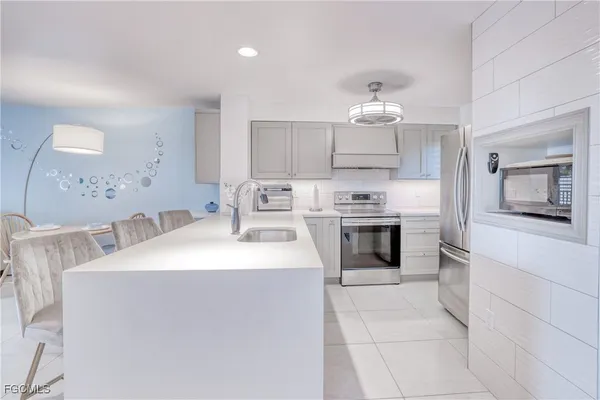 a kitchen with stainless steel appliances a stove top oven and sink