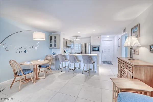 a living room with furniture a table and chairs