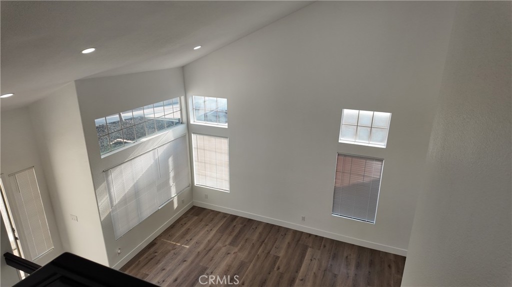 21484 Dickinson Road Moreno Valley, CA 92557 - Photo 6 of 10 a view of an empty room with wooden floor and a window
