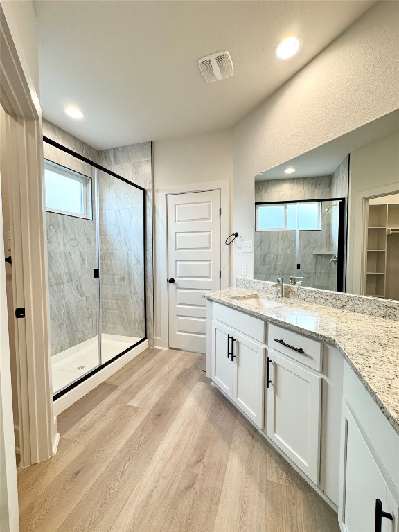 104 Zayd Court, Unit B Jarrell, TX 76537 - Photo 10 of 22 a spacious bathroom with a granite countertop sink mirror and shower