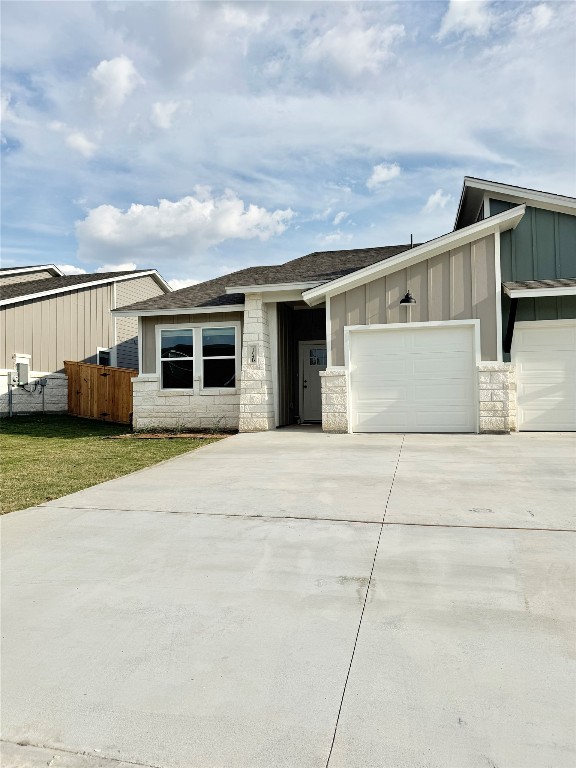 104 Zayd Court, Unit B Jarrell, TX 76537 - Photo 2 of 22 a front view of a house with a yard and garage