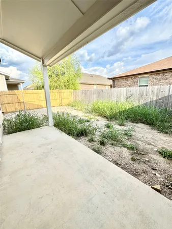 an empty room with a ceiling fan and wooden floor