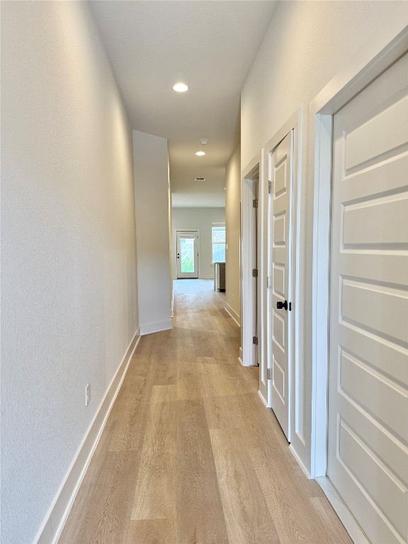 104 Zayd Court, Unit B Jarrell, TX 76537 - Photo 4 of 22 a view of a hallway with wooden floor and a bathroom