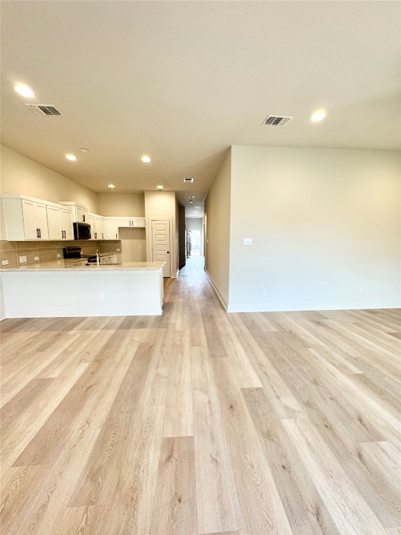 104 Zayd Court, Unit B Jarrell, TX 76537 - Photo 21 of 22 a view of a kitchen with a sink and cabinets