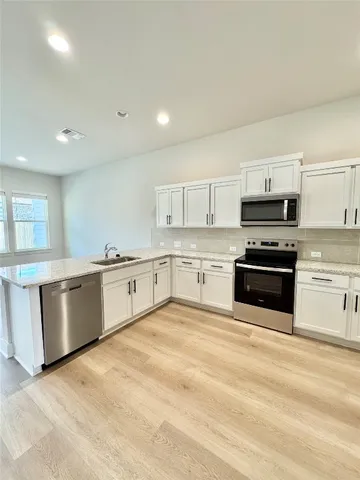 a view of a kitchen with a sink and cabinets