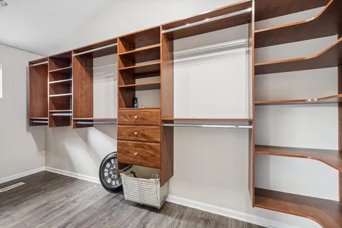 a view of walk in closet with clothes and shoes