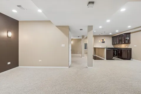 an empty room with kitchen appliances and windows