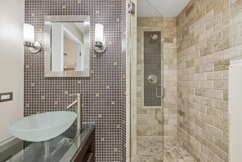 a bathroom with a sink toilet and shower