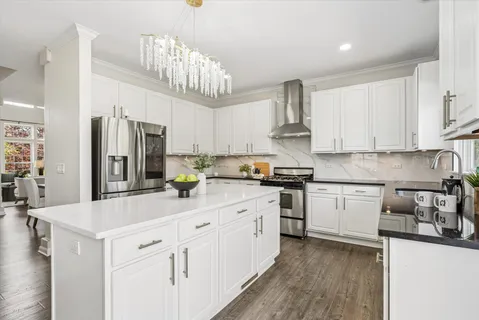 a kitchen with stainless steel appliances a sink stove and refrigerator
