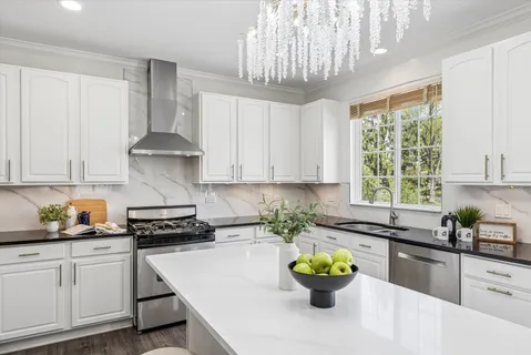 a kitchen with a sink a window and appliances
