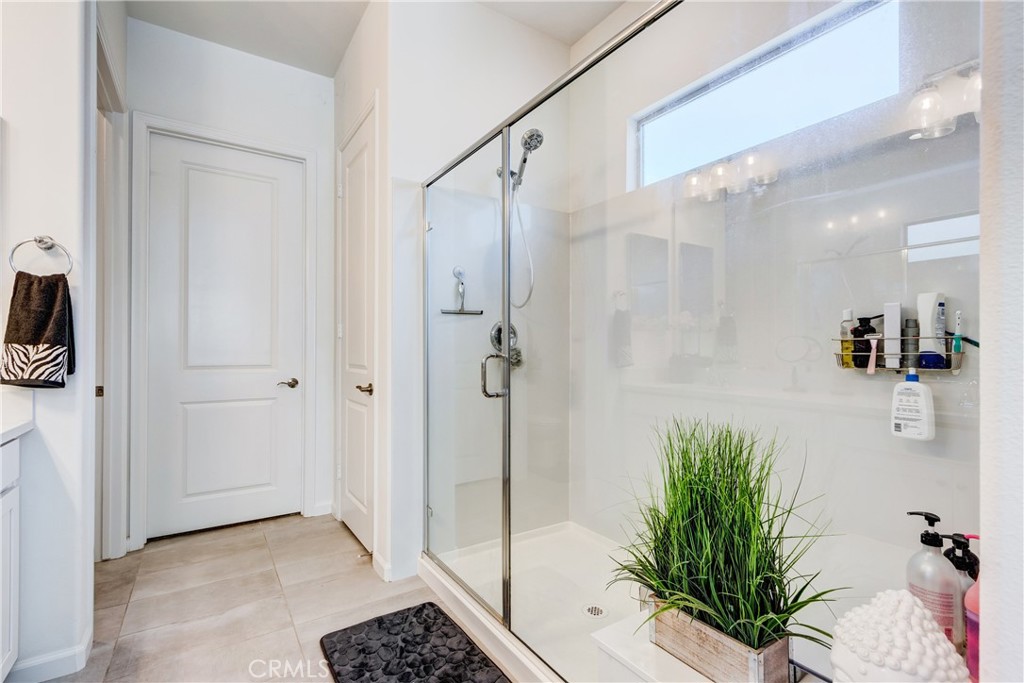 11137 Briar Rose Court Corona, CA 92883 - Photo 30 of 75 a bathroom with a shower and a mirror