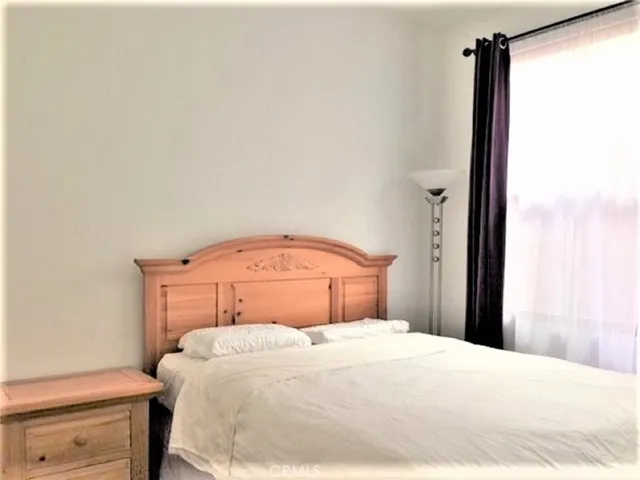 a bedroom with a bed and a closet