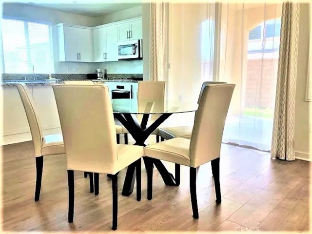 a view of a dining room with furniture and wooden floor
