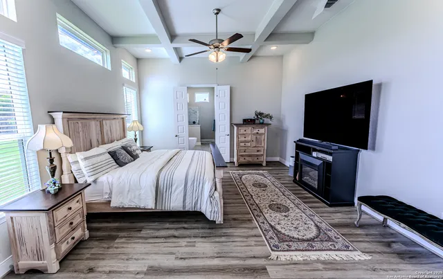 a bedroom with a bed and a flat screen tv