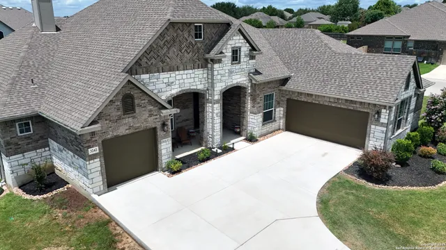 a view of a house with wooden fence