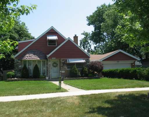 10607 Austin Avenue Chicago Ridge, IL 60415 - Photo 1 of 1 a front view of a house with a yard