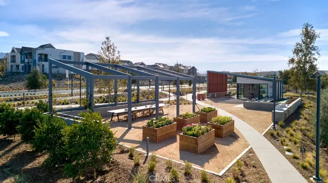 a view of a patio with couches chairs potted plants and water view