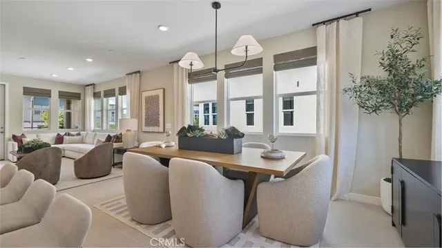 a living room with furniture a window and a chandelier