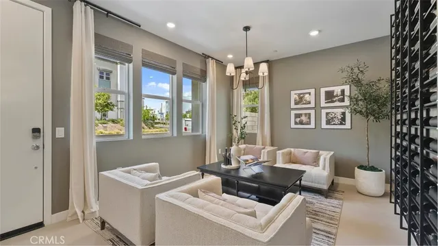 a living room with furniture and a chandelier