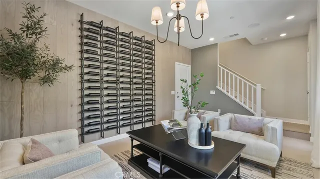 a living room with furniture and chandelier