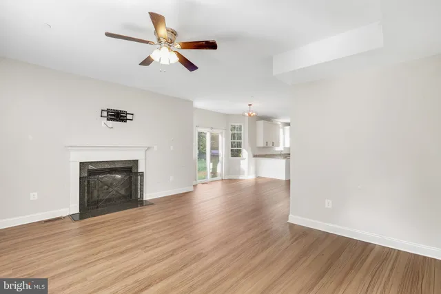 a view of a hallway with wooden floor and entryway