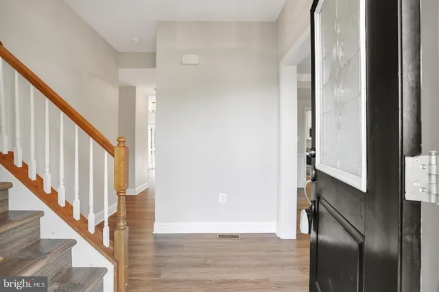 a view of entryway with wooden floor and stairs