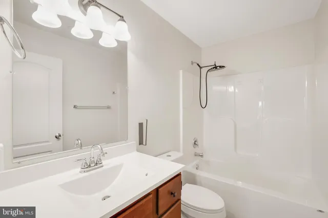 a view of a house with a big yard plants and large trees