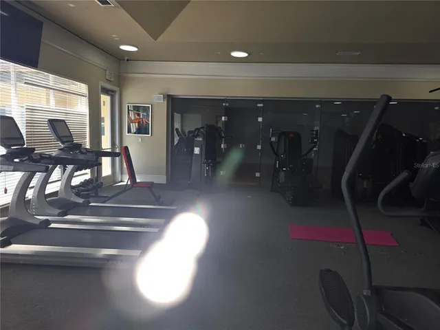 a living room with fireplace furniture and a floor to ceiling window