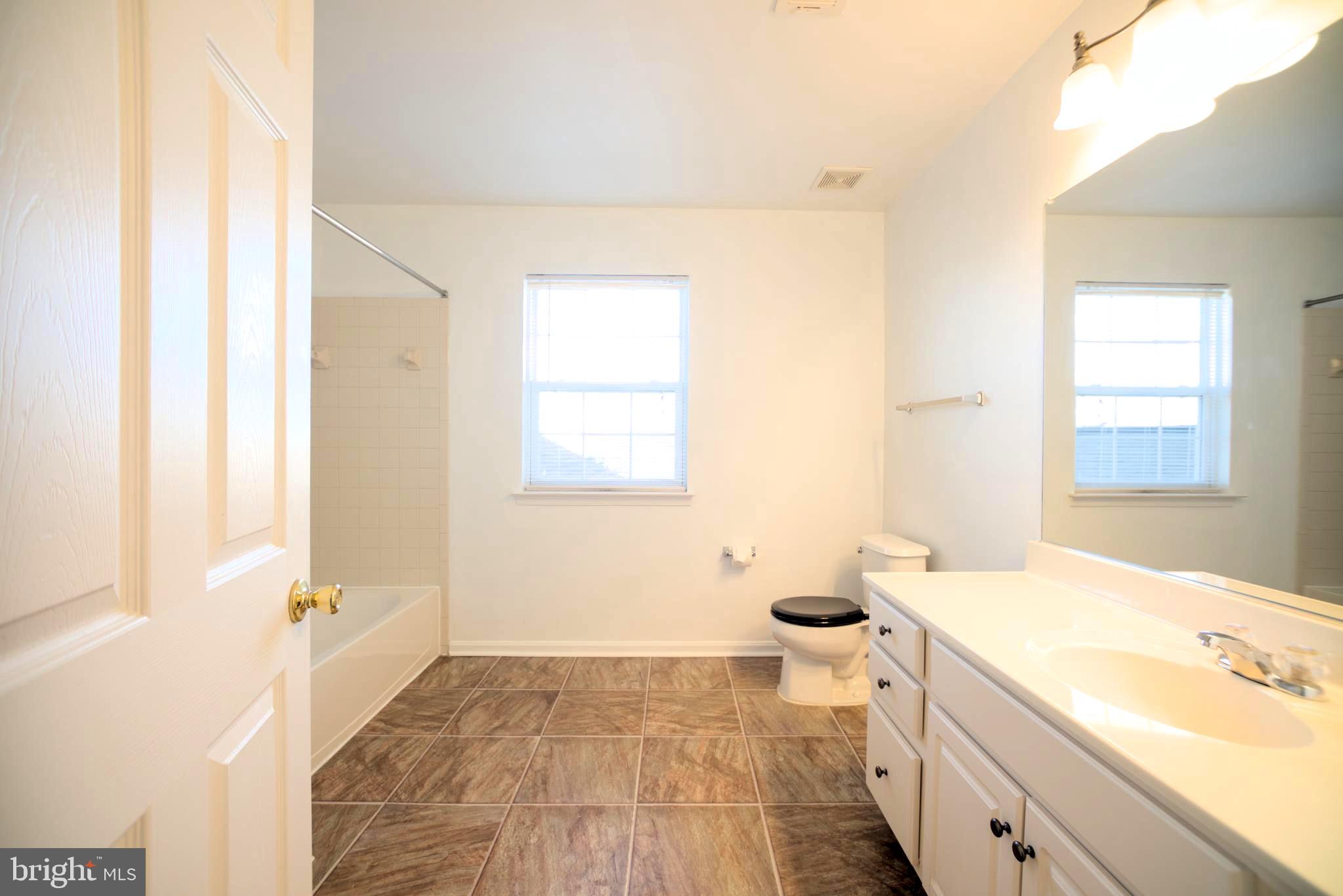 2443 Post Oak Drive Culpeper, VA 22701 - Photo 16 of 48 a bathroom with a tub sink and a mirror