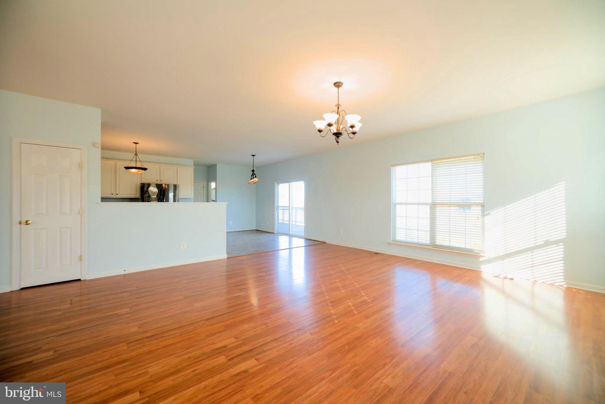 2443 Post Oak Drive Culpeper, VA 22701 - Photo 4 of 48 a view of empty room with wooden floor and kitchen view