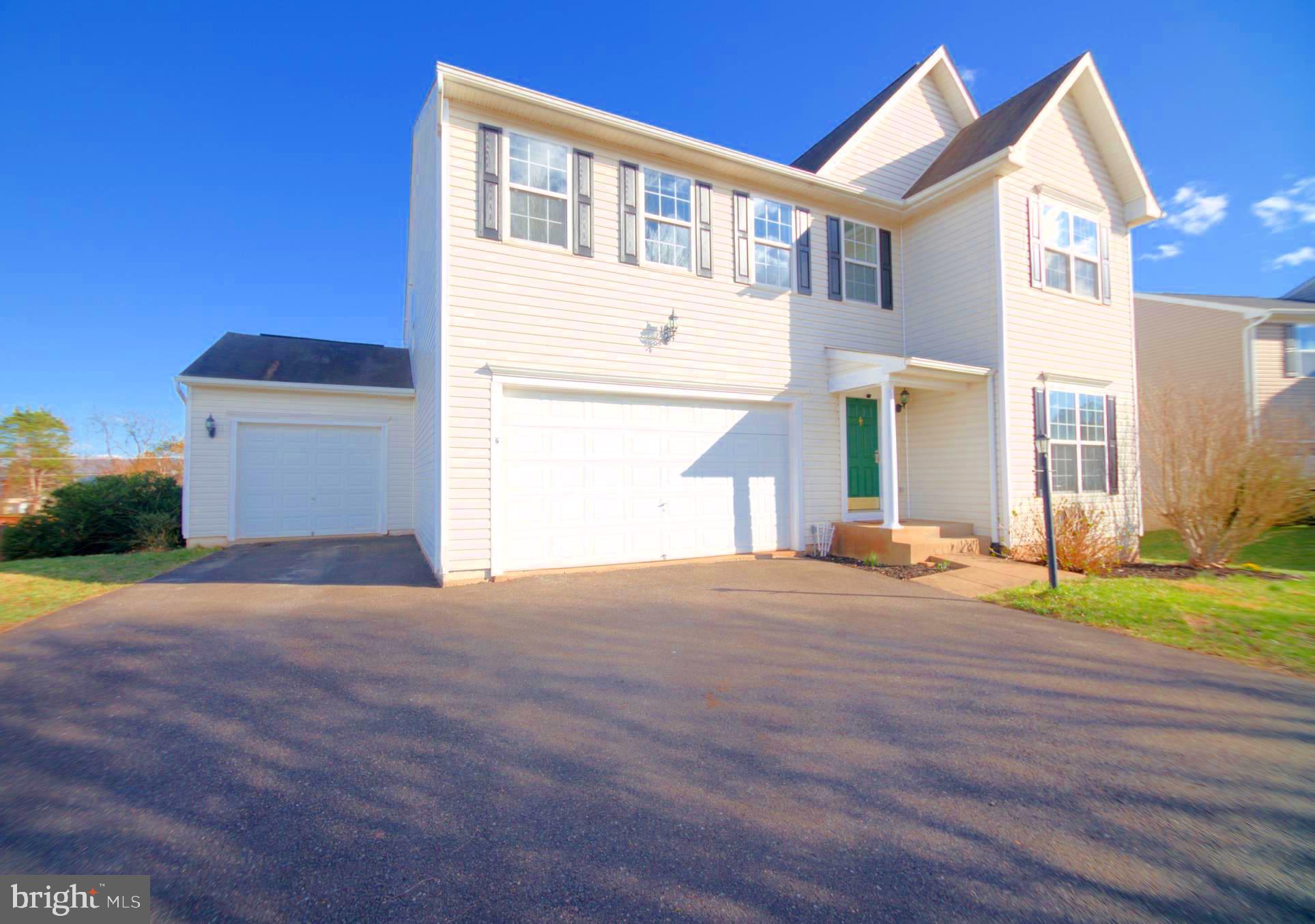 2443 Post Oak Drive Culpeper, VA 22701 - Photo 43 of 48 a front view of a house with a yard and garage