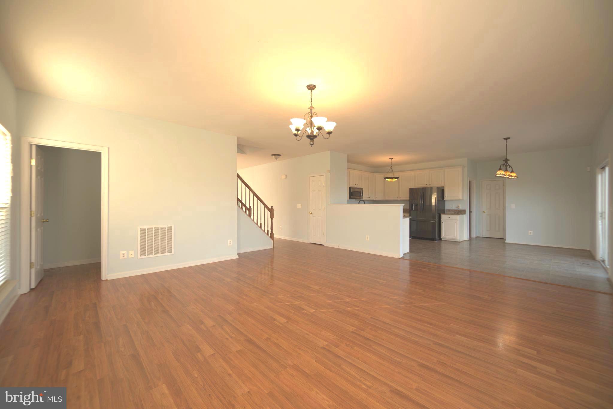 2443 Post Oak Drive Culpeper, VA 22701 - Photo 5 of 48 a view of a room with wooden floor staircase and a kitchen