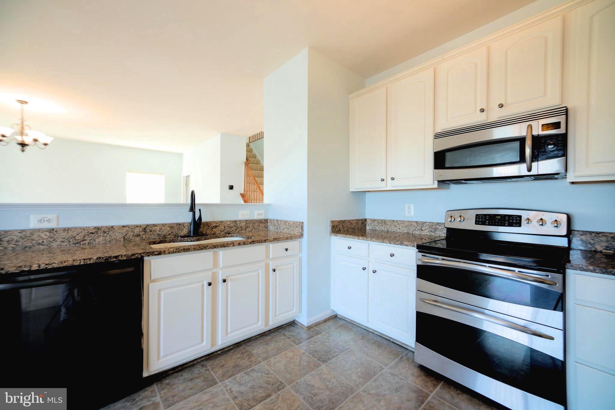 2443 Post Oak Drive Culpeper, VA 22701 - Photo 6 of 48 a kitchen with stainless steel appliances granite countertop a stove and a microwave