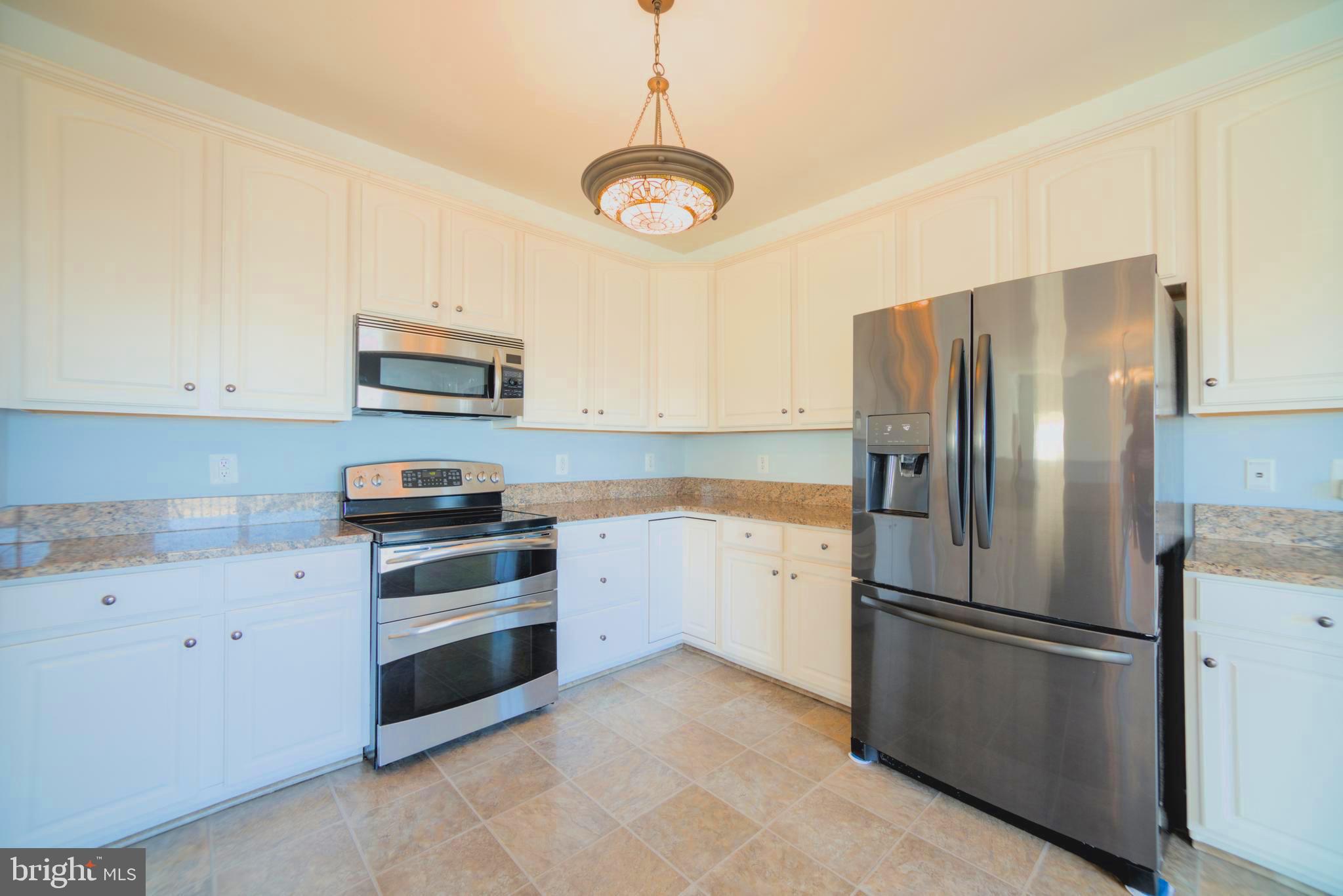 2443 Post Oak Drive Culpeper, VA 22701 - Photo 8 of 48 a kitchen with stainless steel appliances a refrigerator sink and cabinets