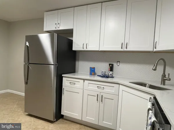 a stove top oven sitting inside of a kitchen