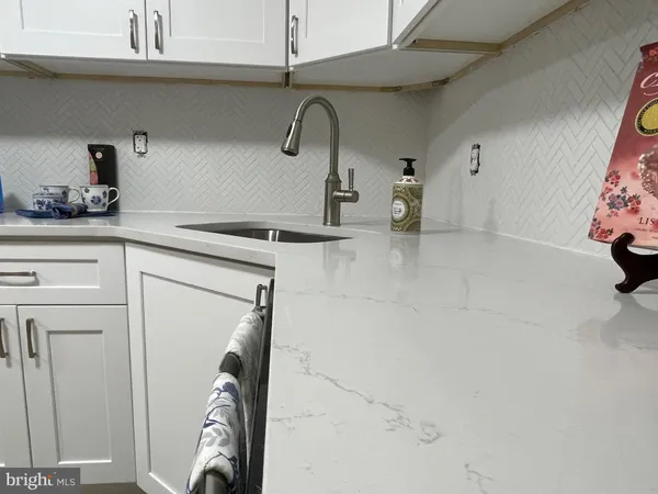 a kitchen with cabinets and stainless steel appliances