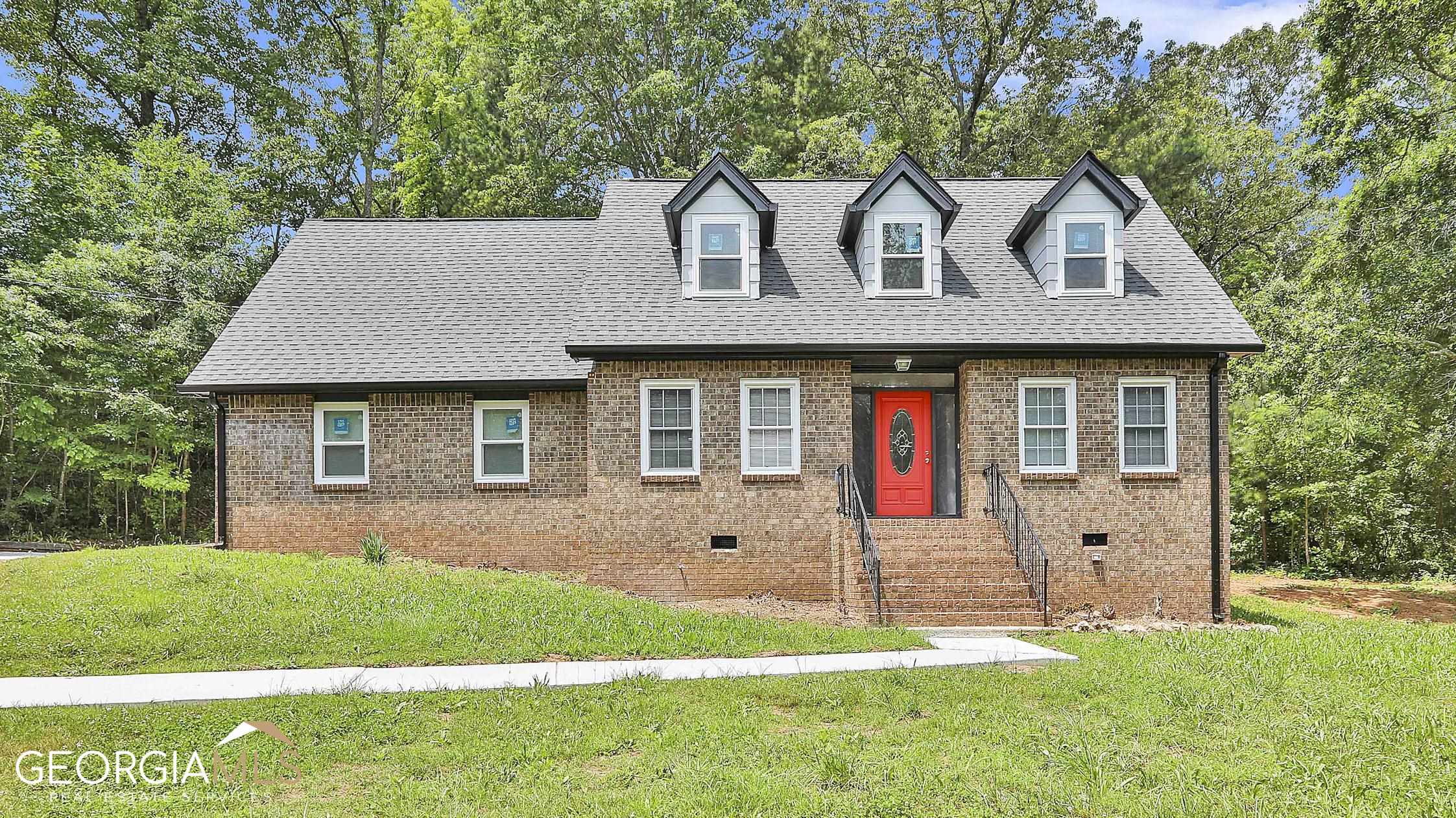 a front view of a house with a yard
