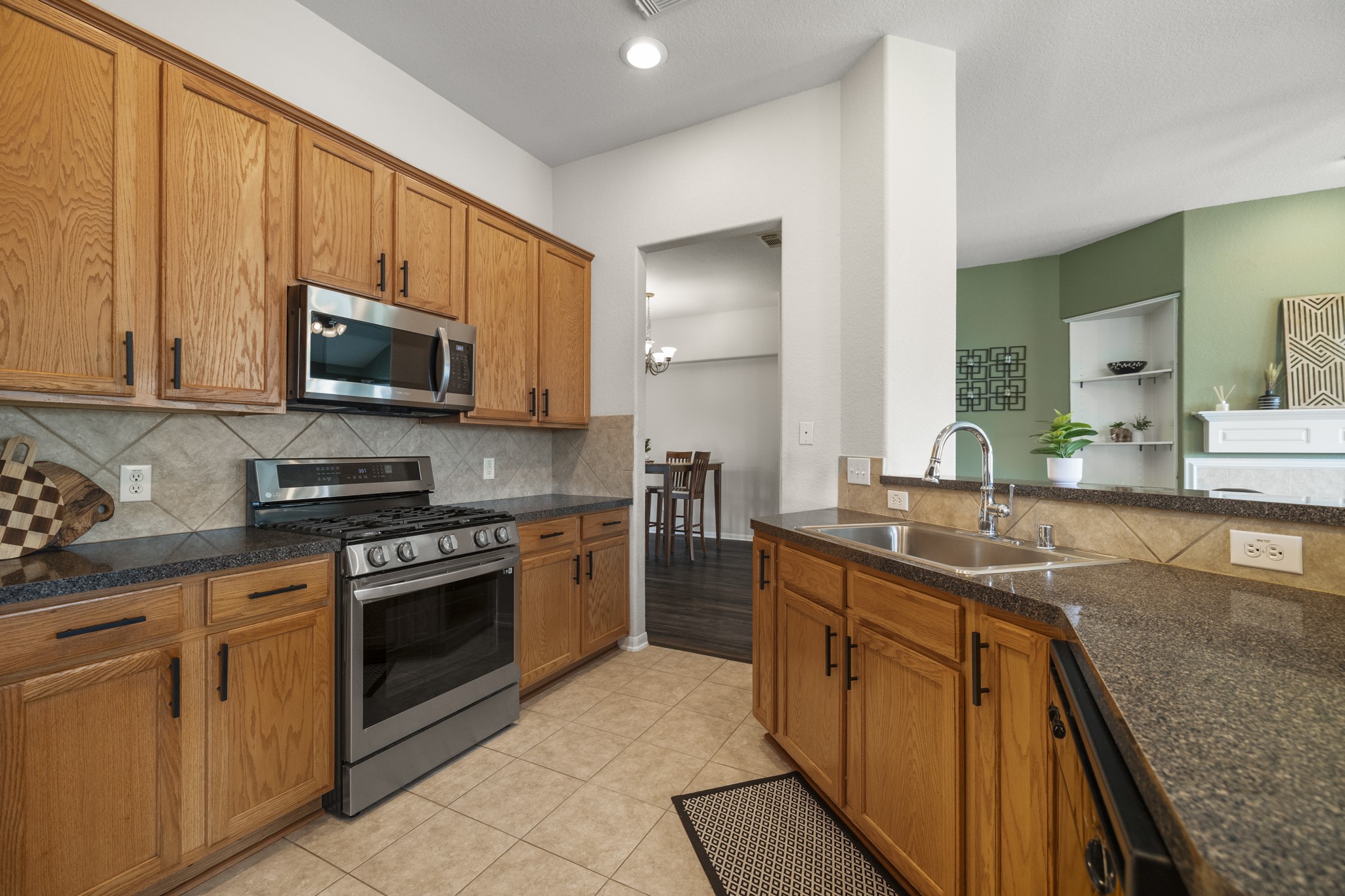3422 Falcon Trail Court Spring, TX 77373 - Photo 10 of 35 a kitchen with stainless steel appliances granite countertop a stove a sink and a microwave