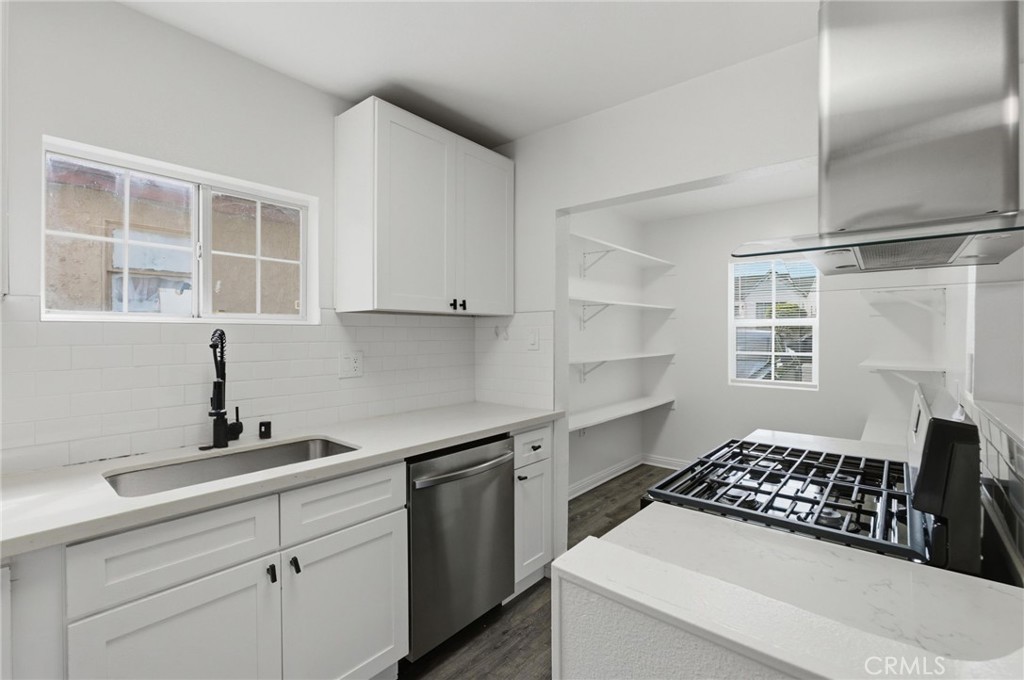 1311 West R Street Wilmington, CA 90744 - Photo 20 of 65 a kitchen with a sink stove and cabinets