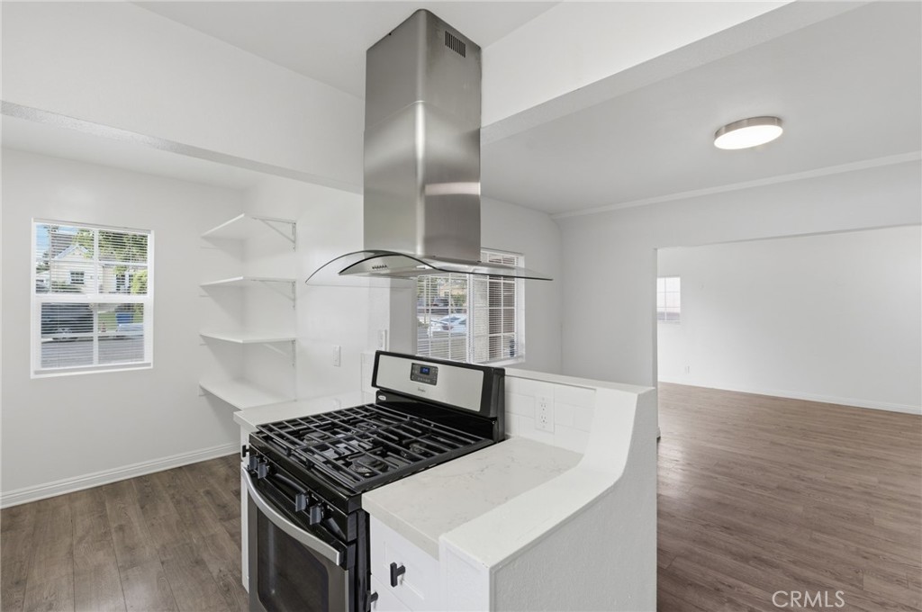 1311 West R Street Wilmington, CA 90744 - Photo 22 of 65 a kitchen with granite countertop a stove and a refrigerator