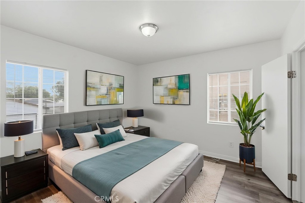 1311 West R Street Wilmington, CA 90744 - Photo 27 of 65 a bedroom with a bed and a potted plant