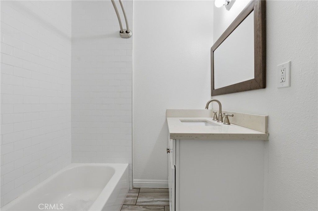 1311 West R Street Wilmington, CA 90744 - Photo 33 of 65 a white bath tub sitting next to a bathroom sink