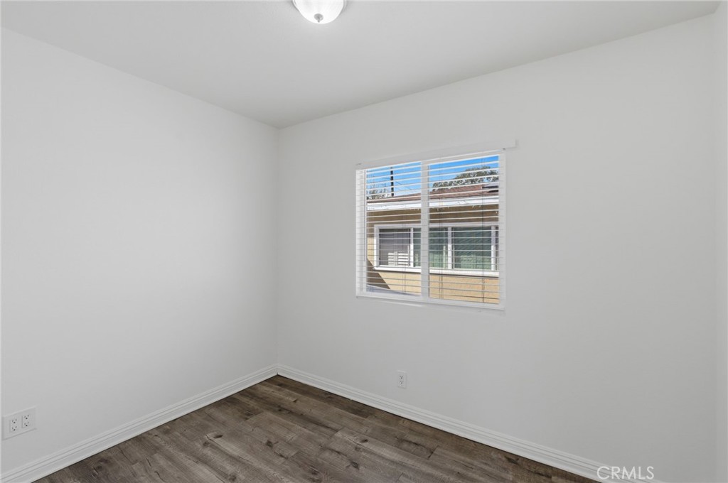 1311 West R Street Wilmington, CA 90744 - Photo 36 of 65 a view of an empty room with wooden floor and a window