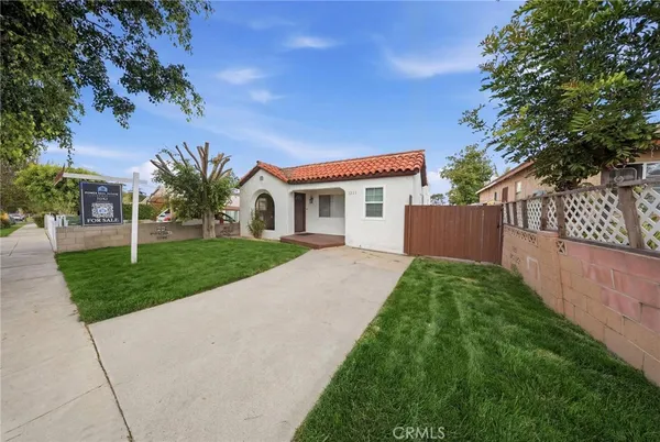 a view of backyard of house and car parked