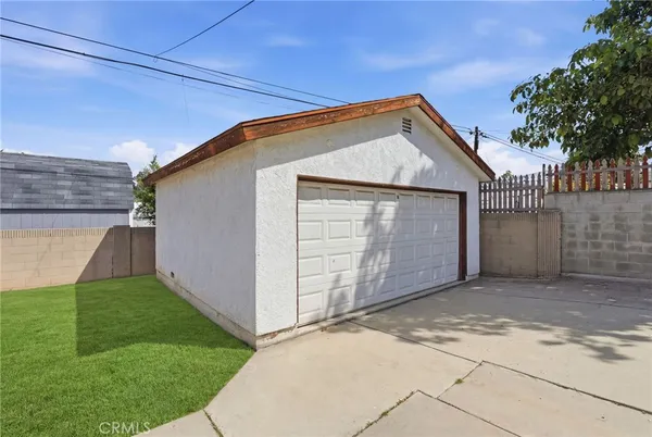 a view of a house with a wooden fence