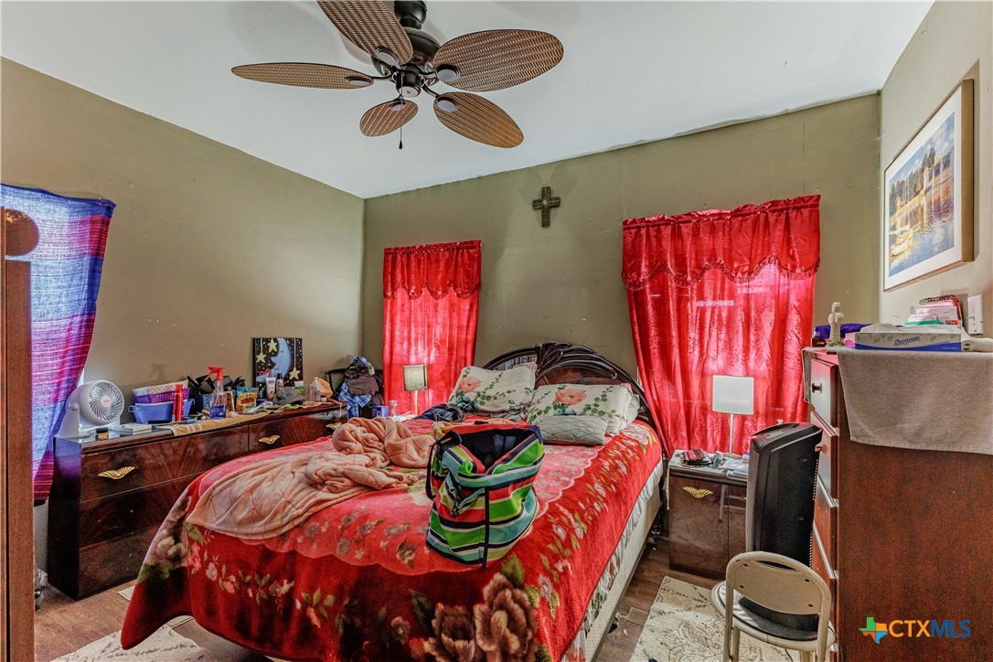 5472 Knob Creek Spur Temple, TX 76501 - Photo 14 of 27 a bedroom with bed and a chandelier