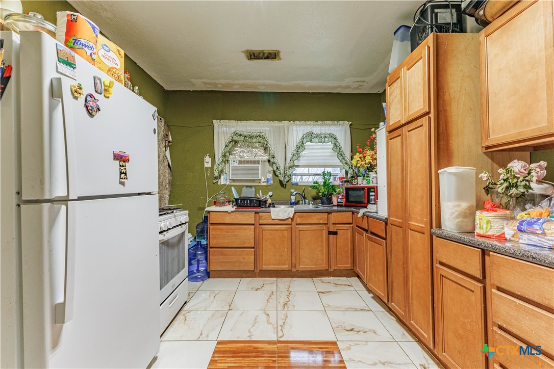 5472 Knob Creek Spur Temple, TX 76501 - Photo 3 of 27 a kitchen with stainless steel appliances granite countertop a refrigerator and a stove