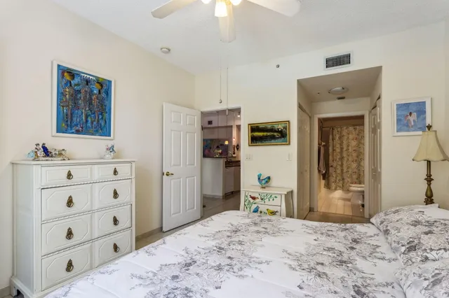 a bedroom with a bed and a dresser in it